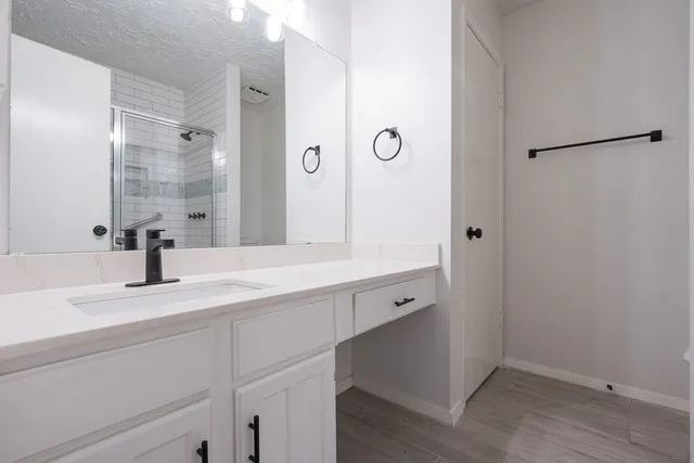 a bathroom with a double vanity sink and mirror