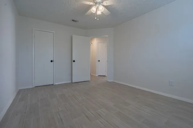 a view of a room with wooden floor