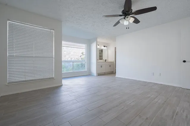 a view of a room with wooden floor and closet area