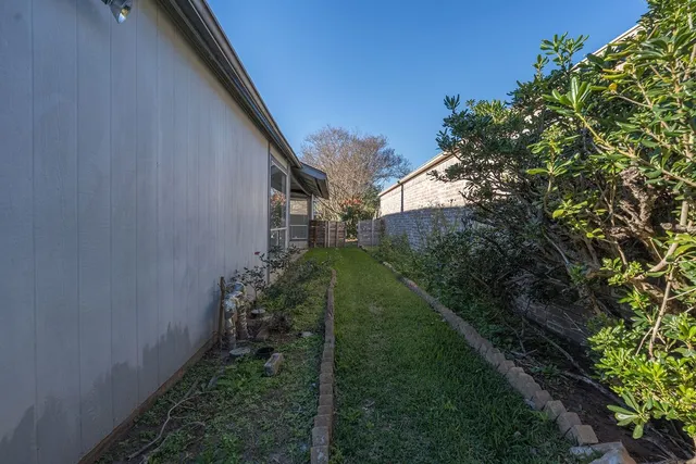 a view of a backyard with large trees