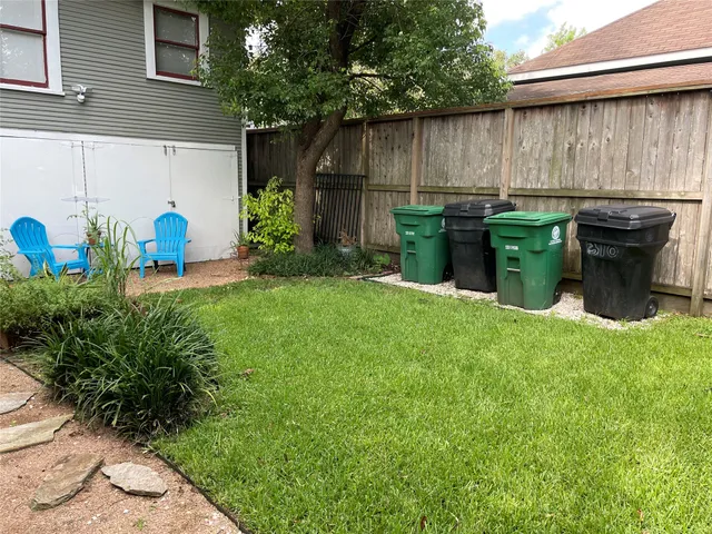 a view of a backyard with plants and a patio