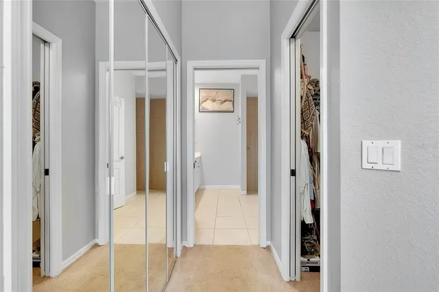 a front view of a house with a yard and potted plants