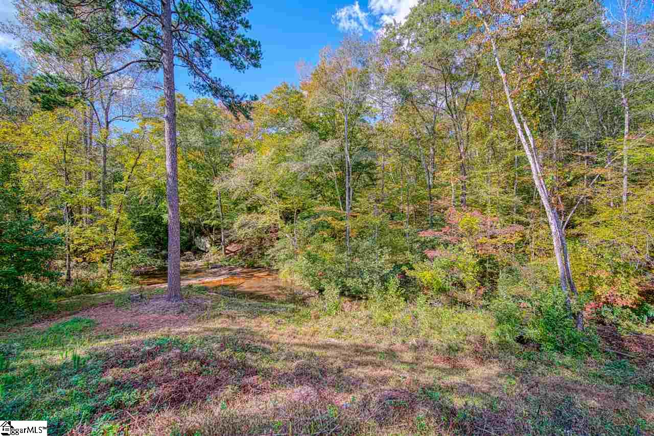751 Holland Ford Road Pelzer, SC 29669 - Photo 28 of 36 Hear the beautiful sound of water rushing around the rocks in the wide creek behind the home from 3 back decks and the large lower level patio