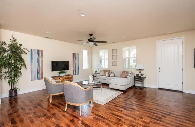 a living room with furniture and wooden floor