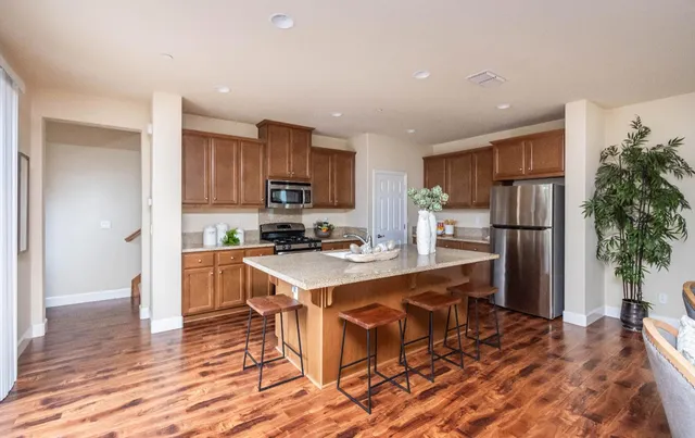 a kitchen with a sink stove top oven and refrigerator