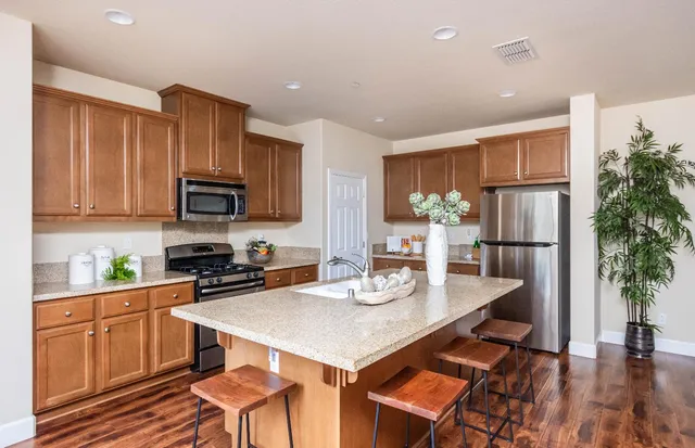 a kitchen with refrigerator and cabinets