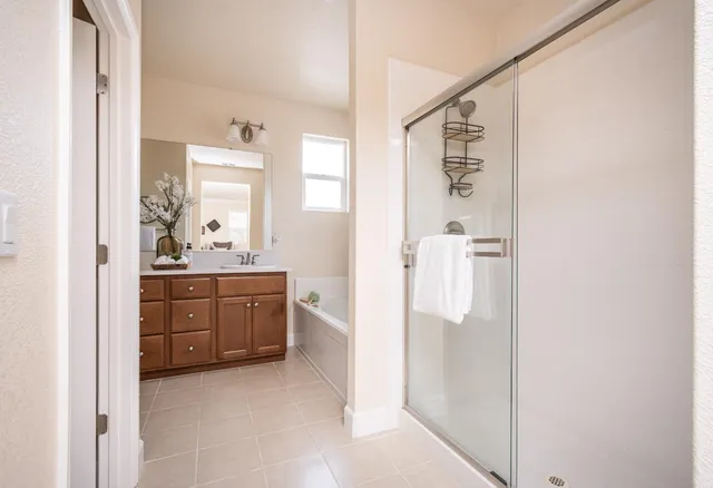 a backyard of a house with table and chairs