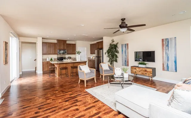 a living room with fireplace furniture and a wooden floor