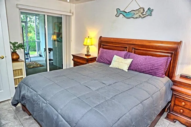 a bedroom with a large bed and a chandelier