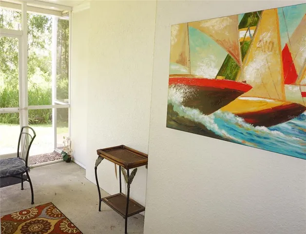 a view of a bedroom with a bed and chair