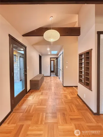 a view of a room with a flesh screen tv and windows