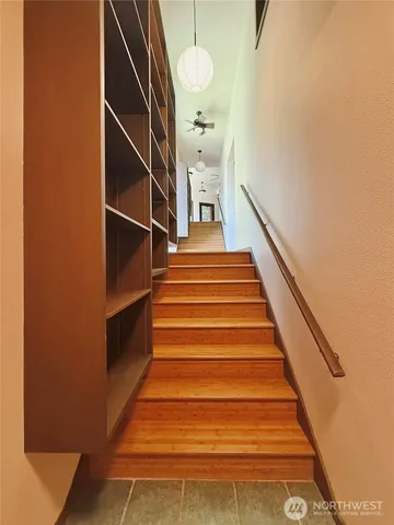 a view of a room with wooden floor and windows