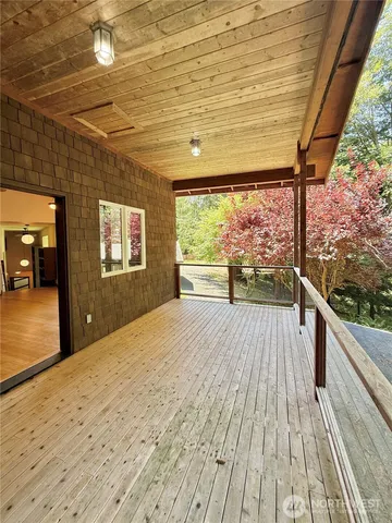 a large room with wooden floor and a ceiling fan