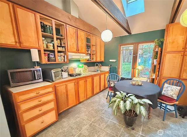 a living room with furniture gym equipment and large window