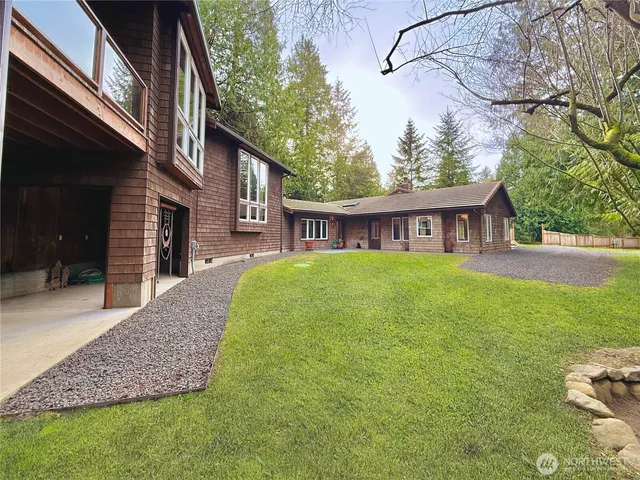 a view of a house with a yard and deck