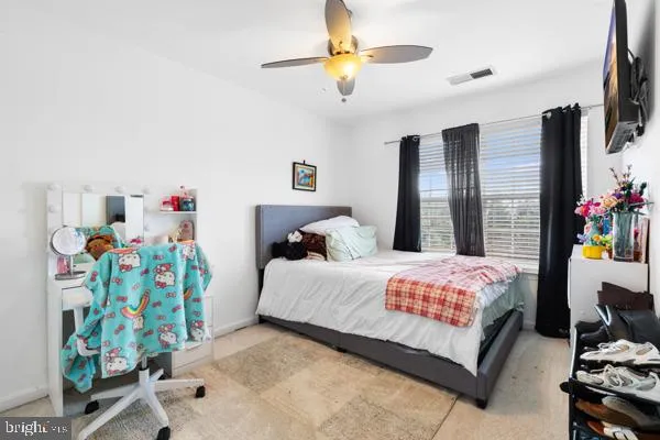 a bedroom with bed and a window