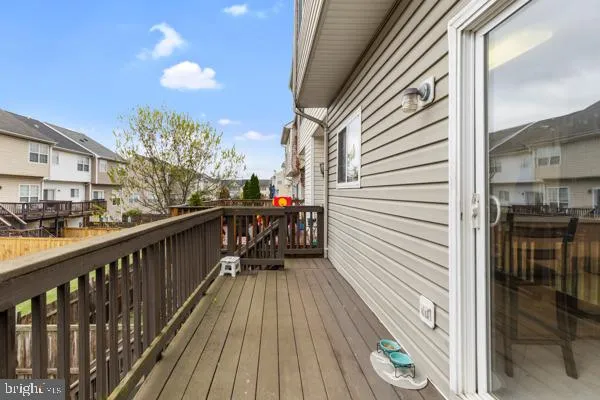 a balcony with wooden floor and city view