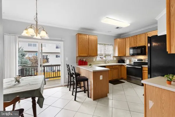 a kitchen with a sink refrigerator and cabinets