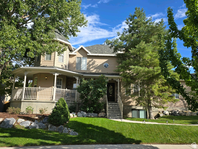 View of front facade charming design with mature trees and lots of character