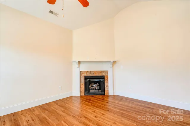 a view of an empty room with a fireplace
