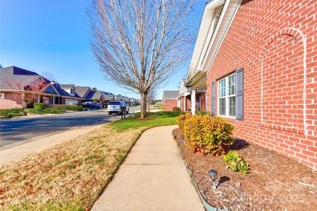 a front view of a building with a garden