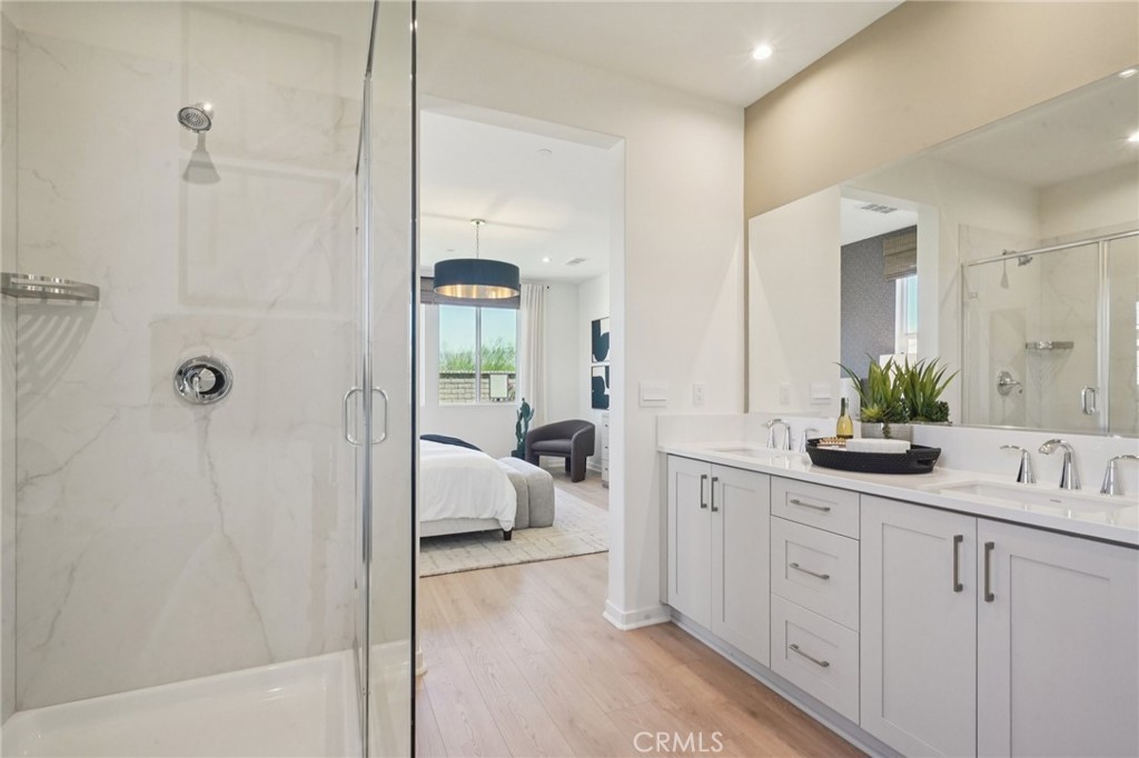 73525 Raphael Drive Palm Desert, CA 92211 - Photo 20 of 41 a en suite bathroom with a double vanity sink a large mirror and shower