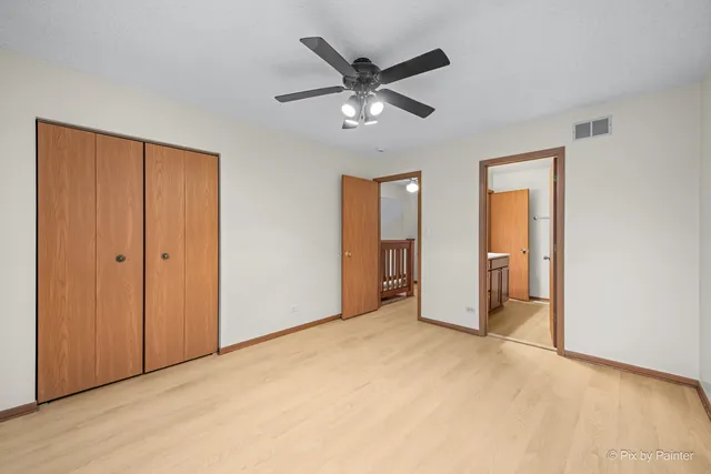 a view of an empty room with a ceiling fan