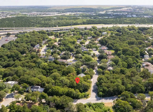an aerial view of town with residential houses with outdoor space and trees