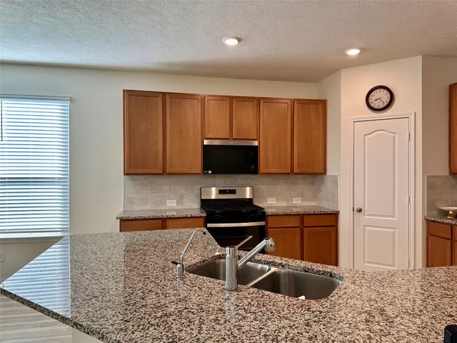 a kitchen with a sink cabinets and stainless steel appliances