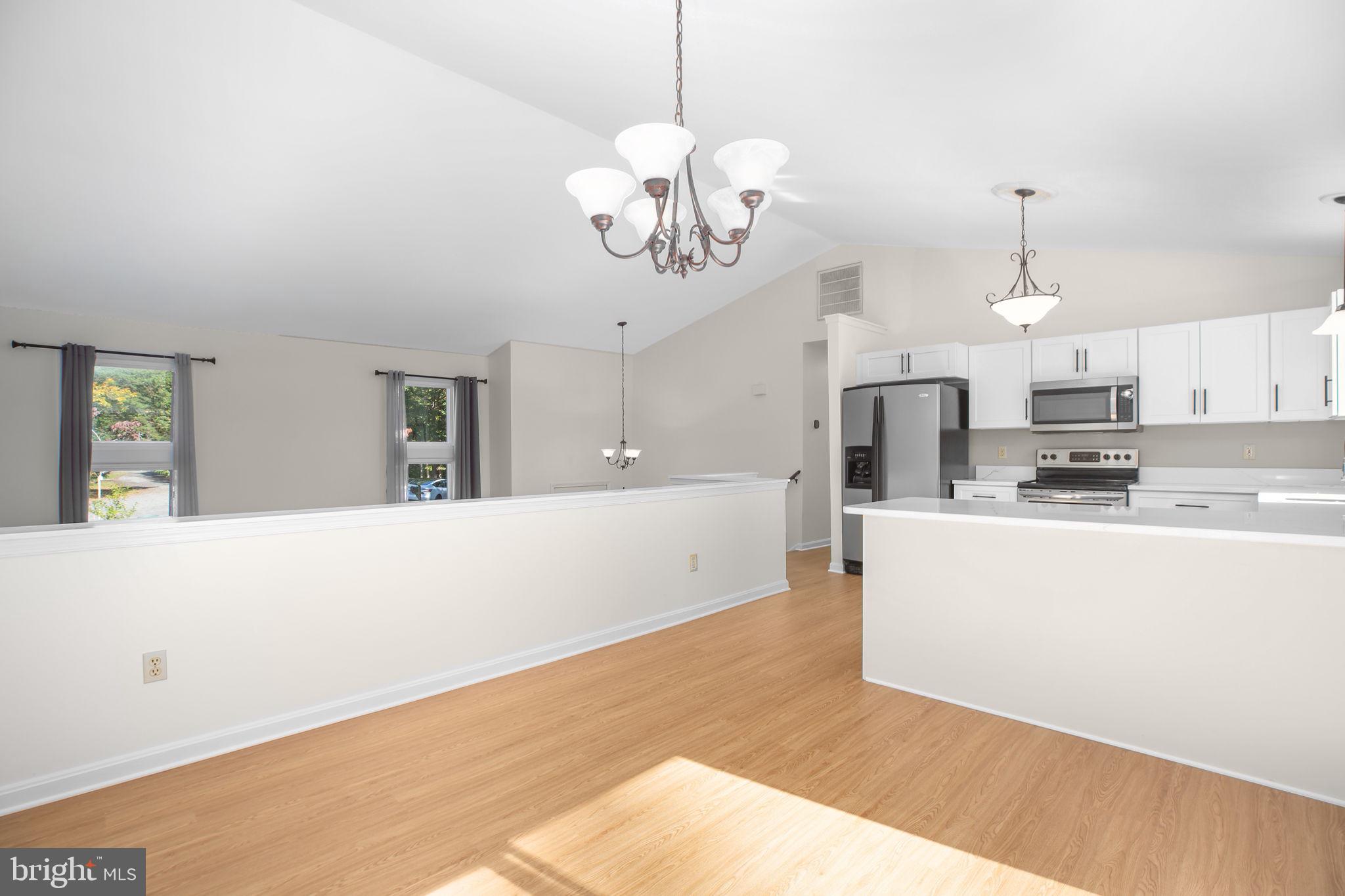 8 Rutledge Cove Ruther Glen, VA 22546 - Photo 14 of 46 a kitchen with stainless steel appliances granite countertop a refrigerator a stove oven a sink dishwasher and white cabinets with wooden floor