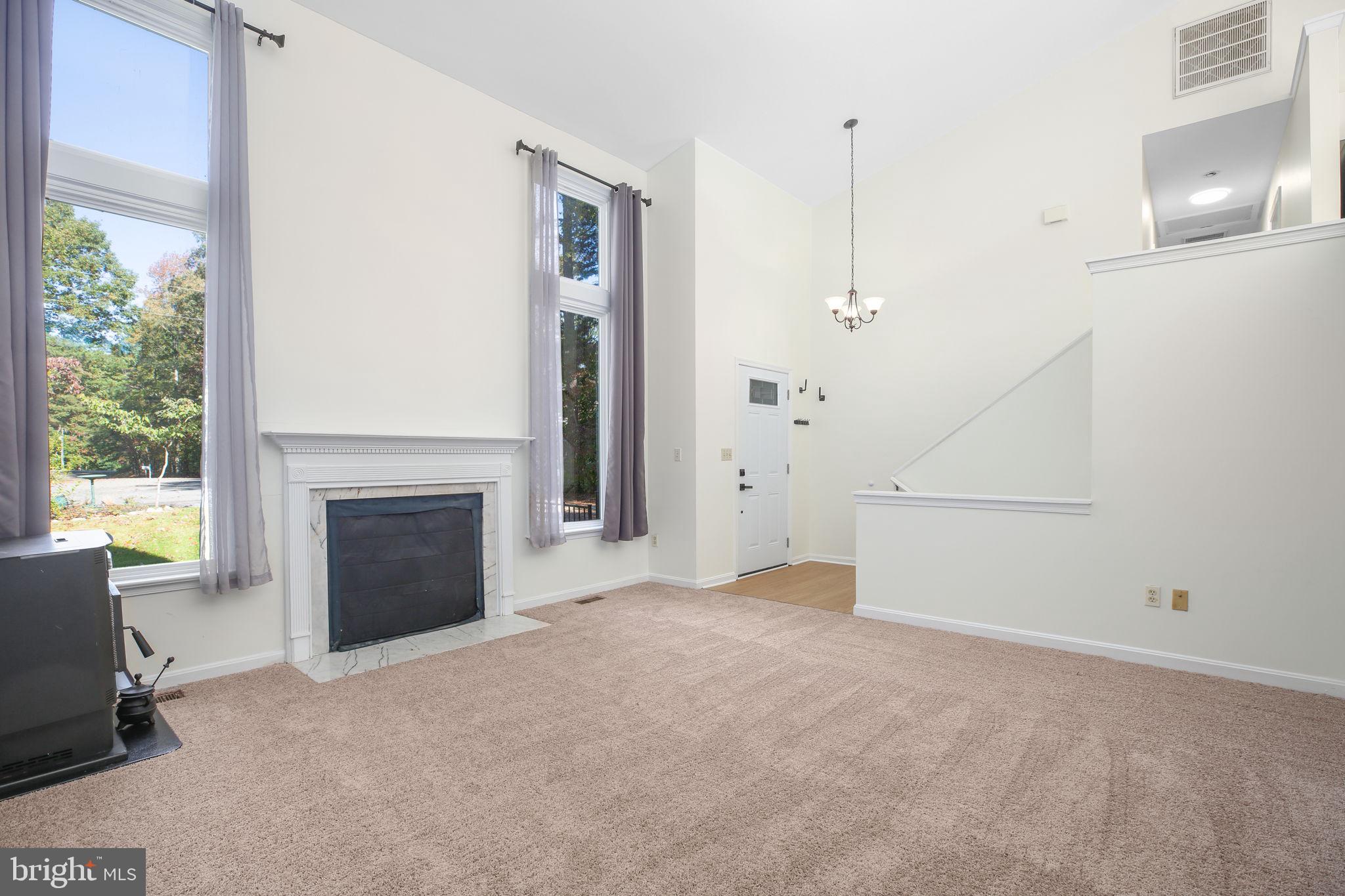 8 Rutledge Cove Ruther Glen, VA 22546 - Photo 6 of 46 a view of empty room with fireplace and windows