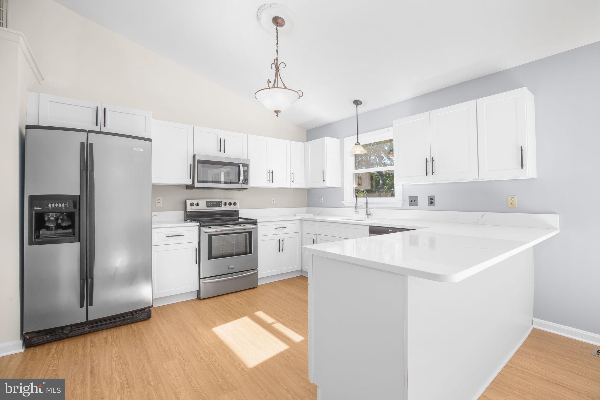 8 Rutledge Cove Ruther Glen, VA 22546 - Photo 9 of 46 a kitchen with a sink stainless steel appliances and white cabinets