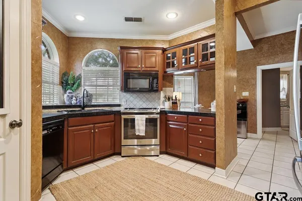 a spacious bathroom with a granite countertop sink and a mirror