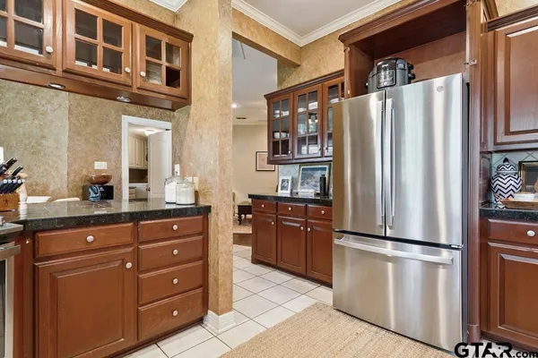 a kitchen with stainless steel appliances granite countertop a refrigerator and a sink