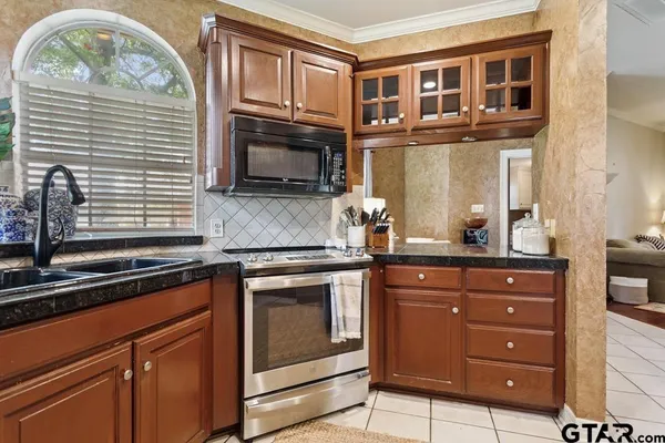 a kitchen with stainless steel appliances granite countertop a stove and a microwave