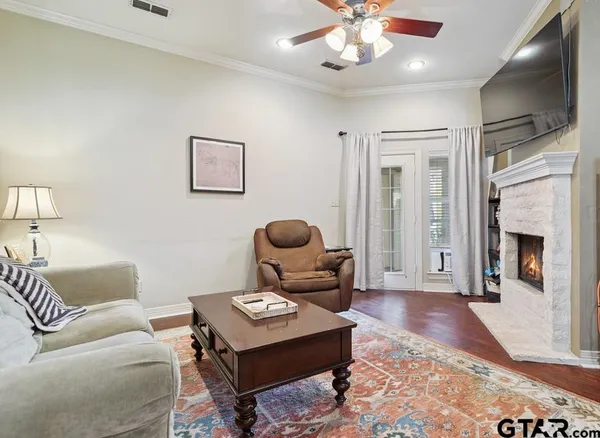 a living room with furniture a fireplace and window