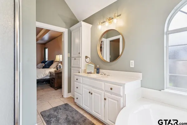 a en suite bathroom with a double vanity sink and a mirror