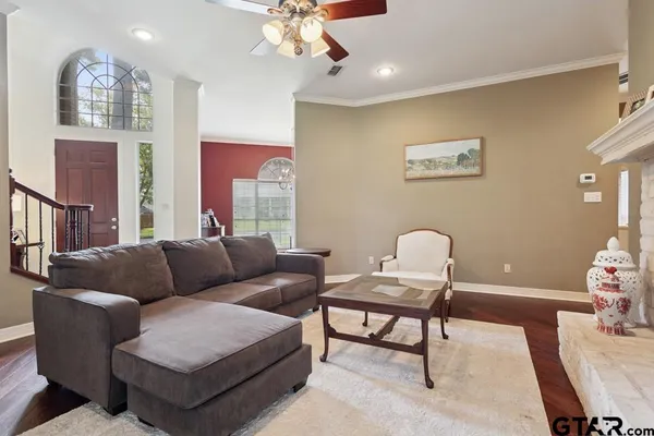 a living room with furniture and a potted plant