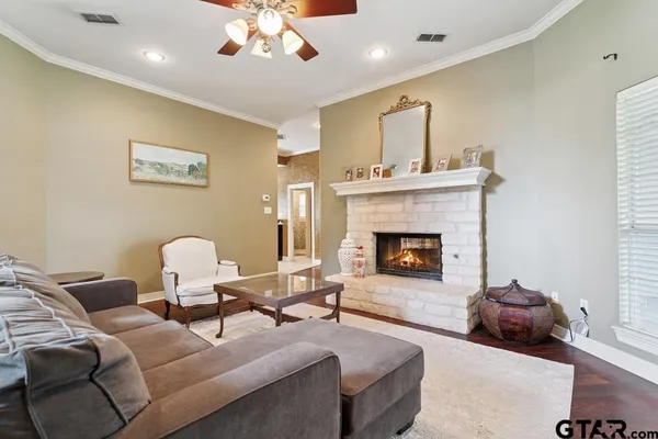 a living room with furniture and a fireplace
