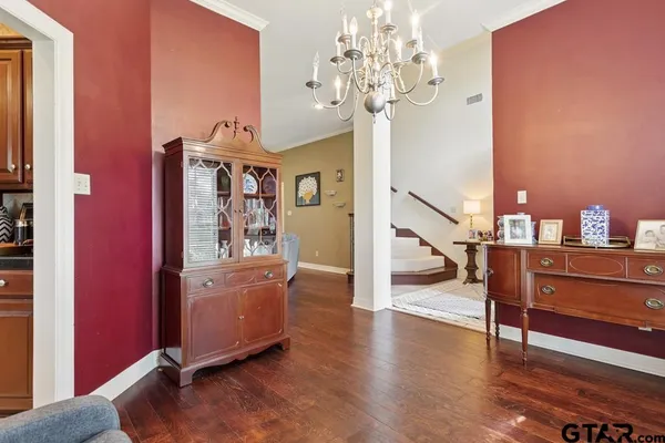 a view of a livingroom with wooden floor and chandelier