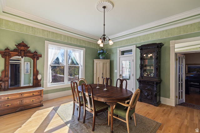 390 North 100 West Monroe, UT 84754 - Photo 13 of 167 Dining room with light wood finished floors, crown molding, healthy amount of natural light, and a chandelier