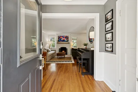 a living room with furniture a rug and a fireplace
