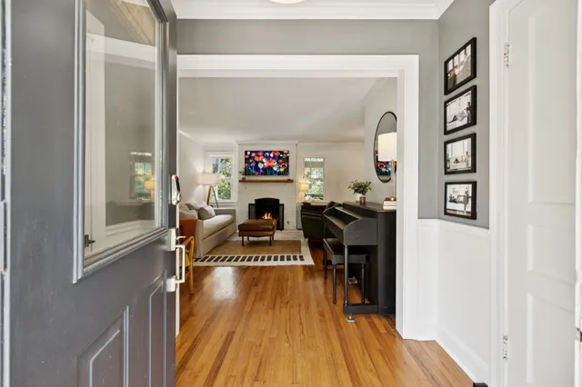 a living room with furniture a rug and a fireplace