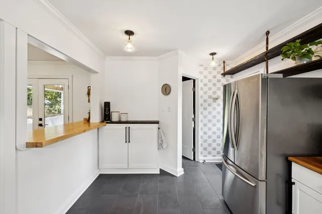 a living room with a bed and a window