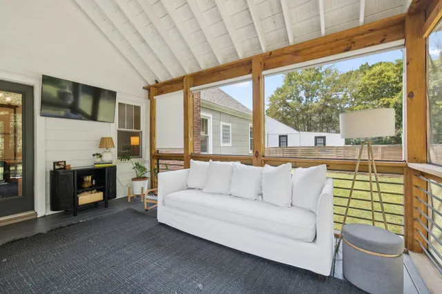 a view of a chair and table in backyard of the house