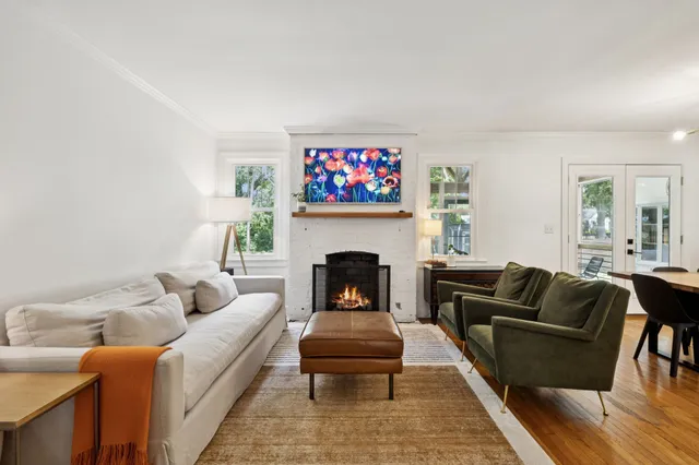 a living room with furniture a rug and a fireplace