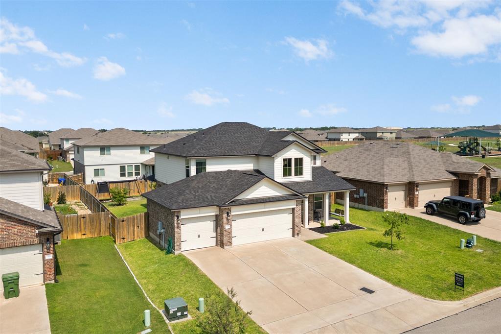 3105 Marston Road Lorena, TX 76655 - Photo 36 of 40 Two-story property featuring a light-colored facade with dark roofing and a two-car garage