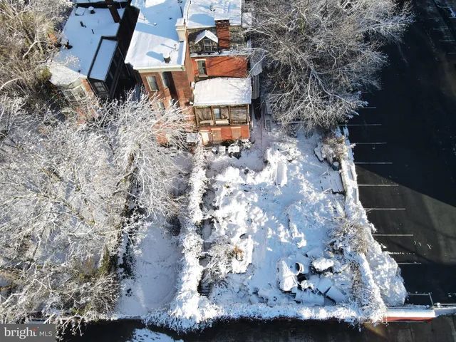 an aerial view of a house with a yard and lake view