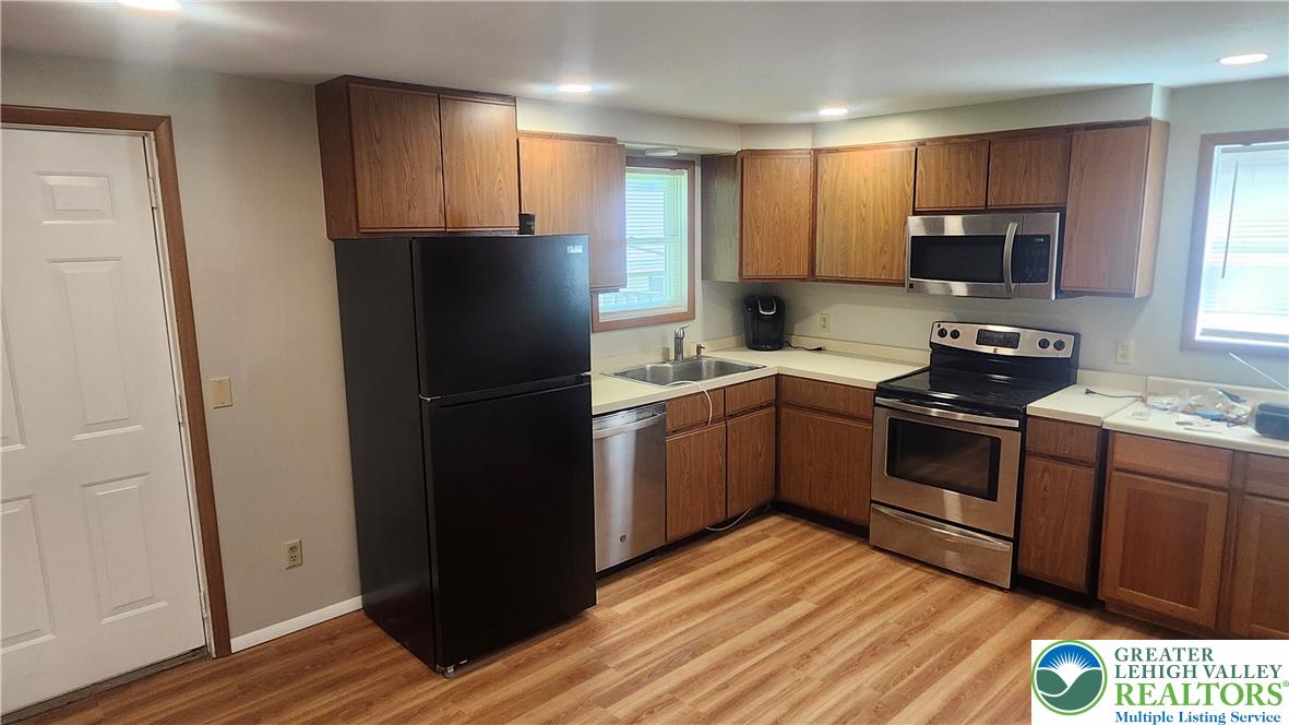 2121 Grove Street Allentown, PA 18104 - Photo 4 of 7 a kitchen with a refrigerator stove and wooden cabinets