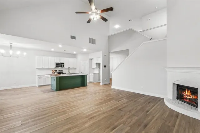 a view of kitchen with sink microwave and refrigerator